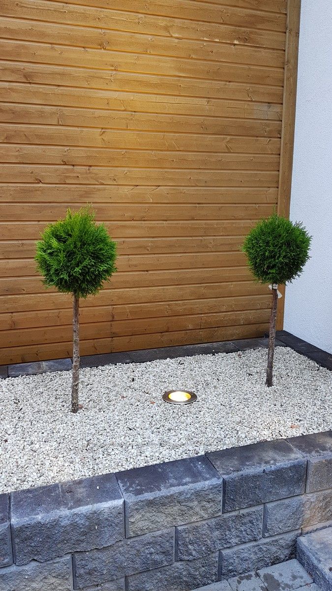 LED LAND LIGHT installed in a flower bed to illuminate plantings and facade.